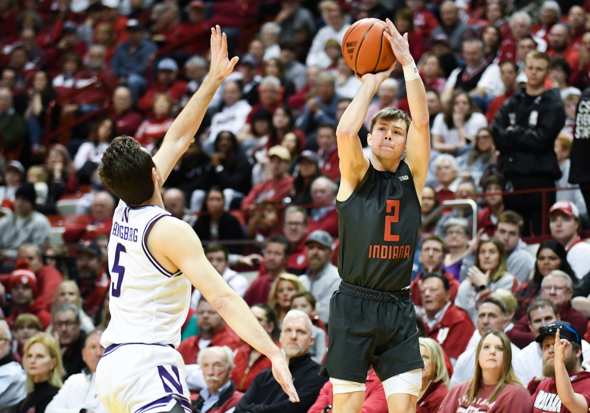 Indiana Hoosiers guard Gabe Cupps (2) makes a three-point basket over Northwestern Wildcats guard Ryan Langborg (5) at Simon Skjodt Assembly Hall.